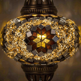 Lit close-up of mosaic glass globe — Amber table lamp glowing (ENV MUN3049)