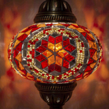Lit close-up of mosaic glass globe — Amber table lamp glowing (ENV MUN3056)