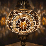 Lit close-up of mosaic glass globe — Amber table lamp glowing (ENV MUN3067)