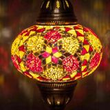 Lit close-up of mosaic glass globe — Amber table lamp glowing (ENV MUN3079)