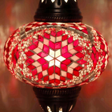 Lit close-up of mosaic glass globe — Red table lamp glowing (ENV MUN3090)