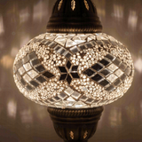 Lit close-up of mosaic glass globe — White table lamp glowing (ENV MUN3098)