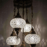 Lit close-up of mosaic glass globe — White chandelier glowing (ENV SLT5N3 (3012))
