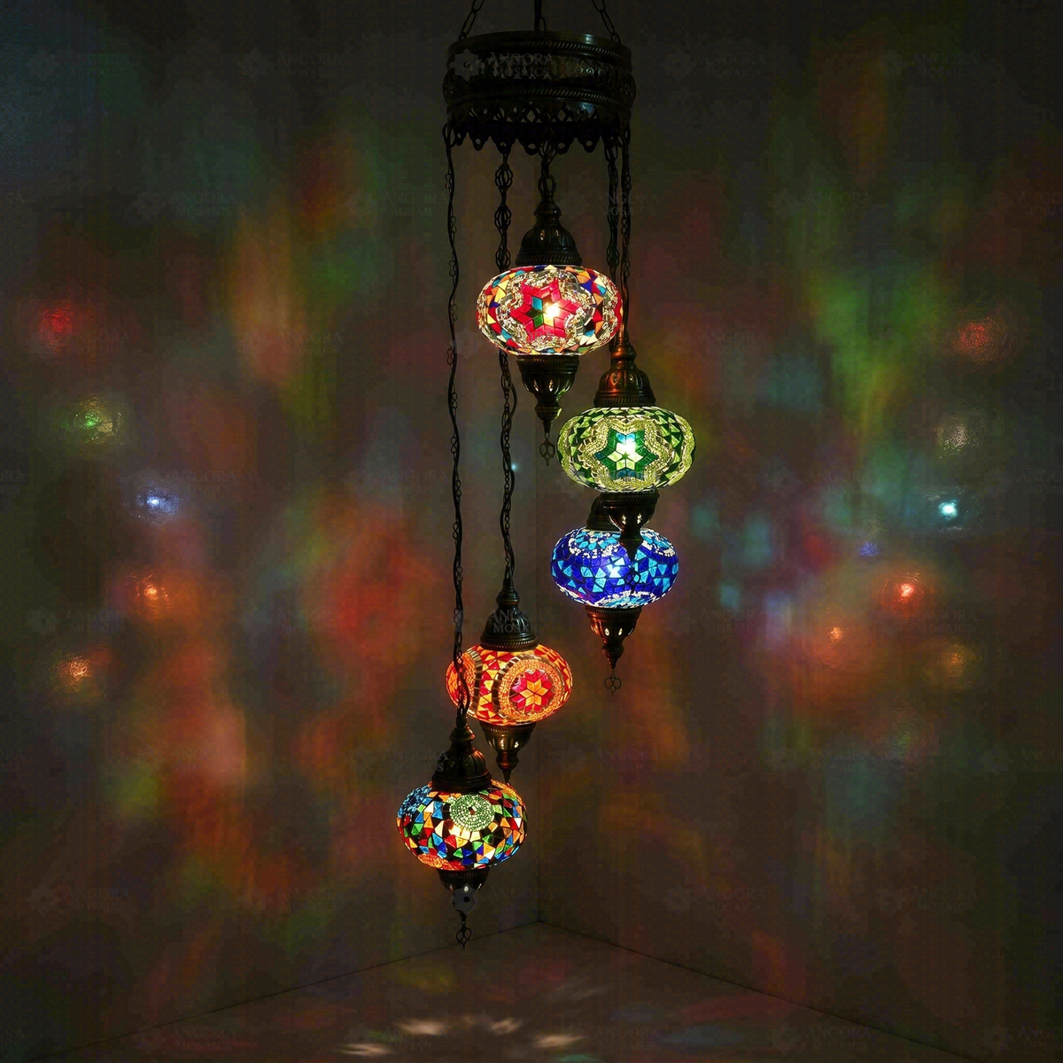 Multicolor 5-Globe Spiral Chandelier, switched on, glowing in a dark room