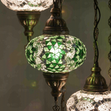 Lit close-up of mosaic glass globe — Green chandelier glowing (HLZ7N3 (3003X4-3068X3))