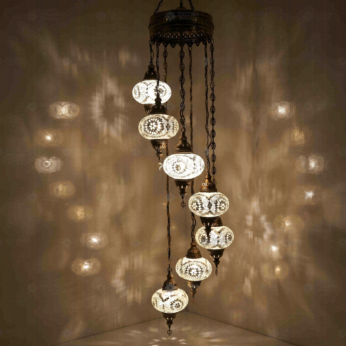 White 7-Globe Spiral Chandelier, switched on, glowing in a dark room